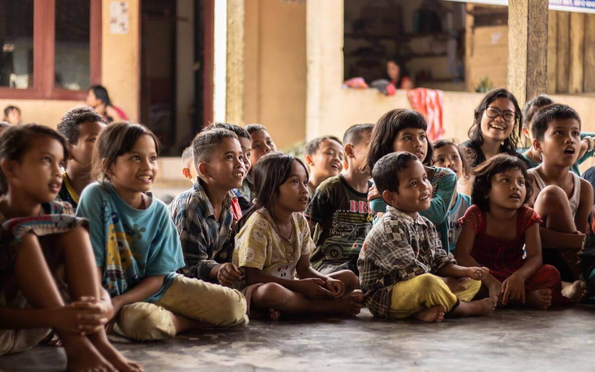 Children siting on the floor with happy faces