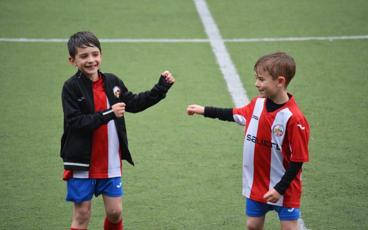 Two boys in a soccer uniform