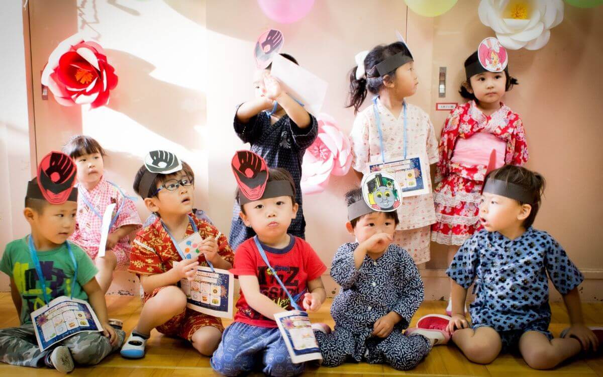 Group of kindergarten kids in different costumes